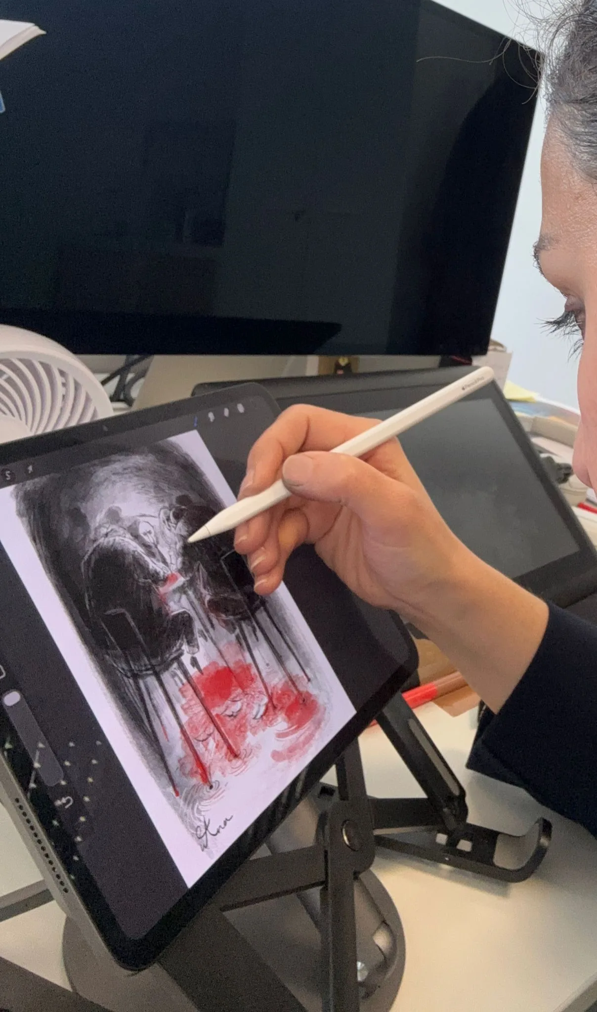 Sana Hosseinpour drawing on a tablet during a class